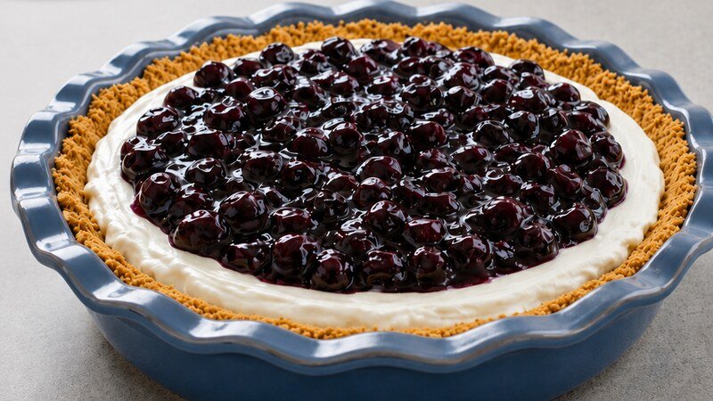 Blueberry Icebox Pie with a creamy filling and glossy blueberry topping in a blue pie dish