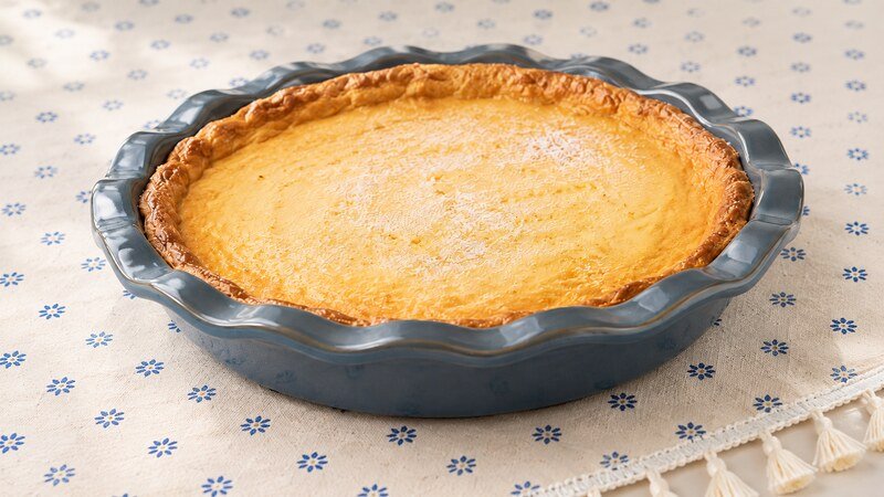 Magic Lemon Pie with a smooth golden lemon filling in a blue pie dish